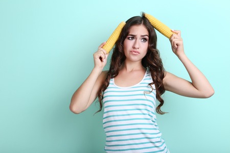 Young woman with corns on mint backgroundの写真素材
