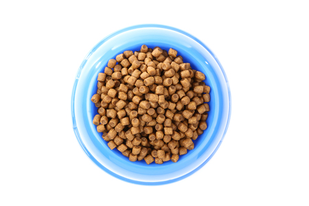 Dry pet food in bowl isolated on white backgroundの写真素材