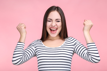 Beautiful young woman on pink backgroundの写真素材