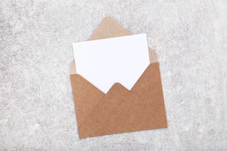 Blank paper with envelope on grey background