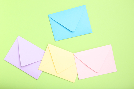 Colorful paper envelopes on green backgroundの写真素材