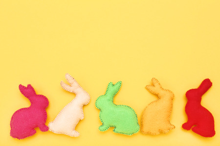 Easter fabric rabbits on yellow backgroundの写真素材