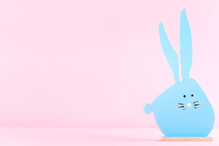 Easter wooden rabbit on pink backgroundの写真素材
