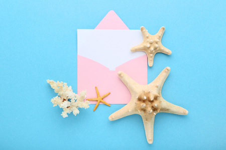 Blank paper with envelope and starfishes on blue backgroundの写真素材