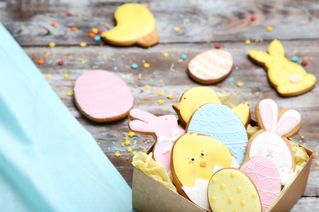 Easter gingerbread cookies in box on wooden tableの写真素材