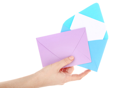 Female hand with colorful paper envelopes on white backgroundの写真素材