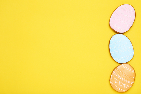 Easter gingerbread cookies on yellow background