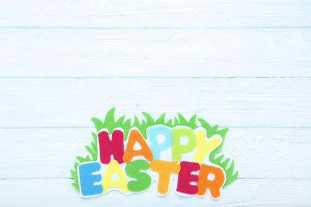 Text Happy Easter on wooden table