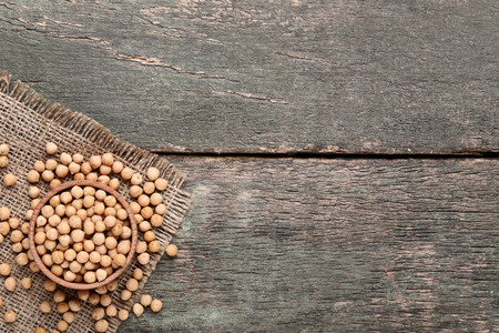 Chickpeas in bowl on grey wooden tableの写真素材