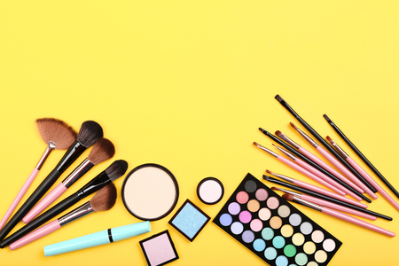Makeup brushes with palette on yellow backgroundの写真素材