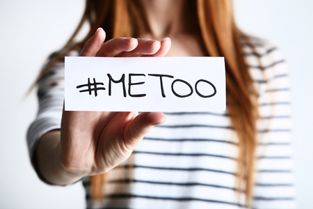 Woman holding paper with text Me Too on grey backgroundの写真素材