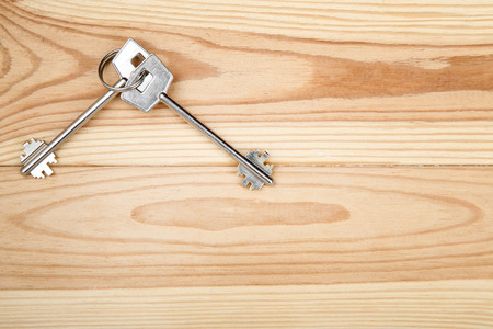 House keys on brown wooden tableの写真素材