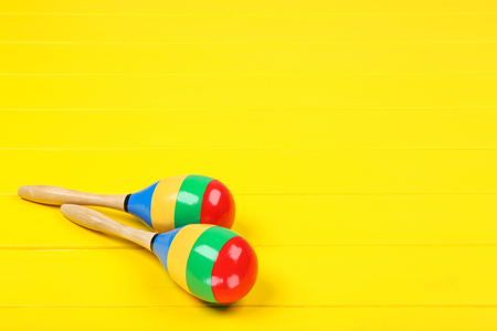 Mexican maracas on yellow wooden table