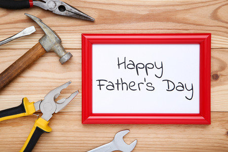 Text Happy Fathers Day with tools on brown wooden tableの写真素材