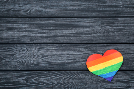 Rainbow paper heart on black wooden tableの写真素材
