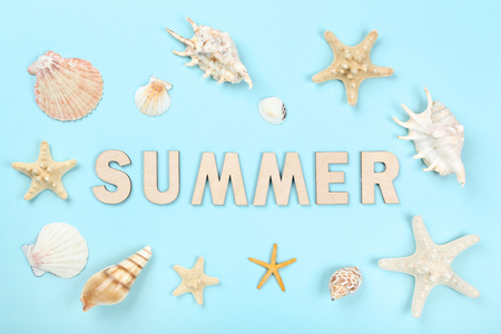 Word Summer with seashells on blue backgroundの写真素材