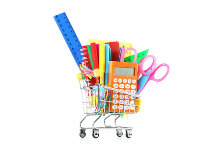 School supplies in shopping cart on white backgroundの写真素材