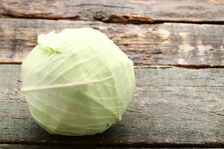 Ripe cabbage on grey wooden tableの写真素材