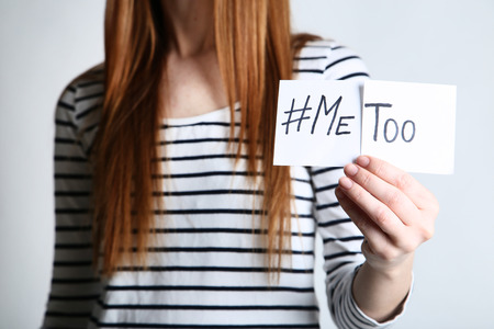 Woman holding paper with text Me Too on grey backgroundの写真素材