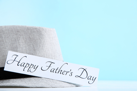 Text Happy Fathers Day with hat on blue backgroundの写真素材