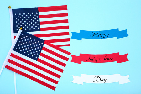 American flags with blank papers on blue background