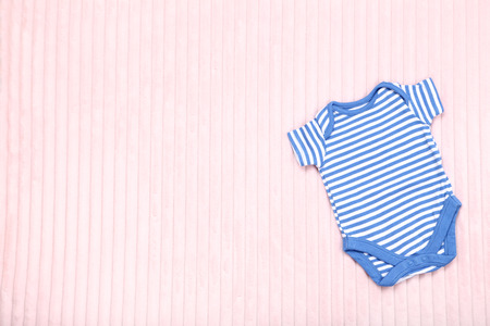 Baby clothes on pink backgroundの写真素材