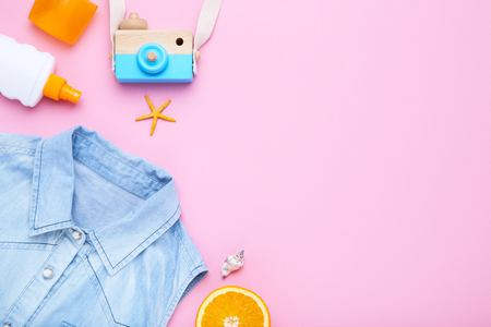 Fashion clothing with seashells and sunscreen on pink backgroundの写真素材