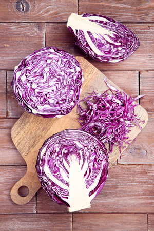 Fresh red cabbages on brown wooden tableの写真素材