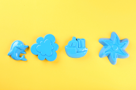 Plastic beach toys on yellow backgroundの写真素材