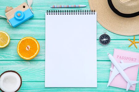 Blank sheet of paper with fruits and airplane model on wooden table