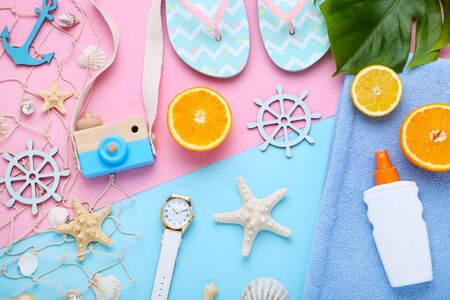 Beach accessories with seashells and fruits on colorful background