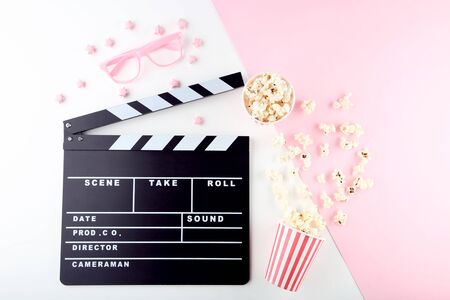 Clapper board with popcorn and pink glassesの写真素材