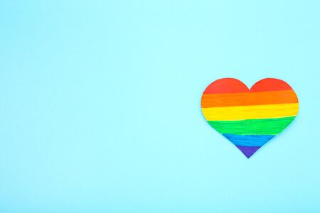 Rainbow paper heart on blue backgroundの写真素材