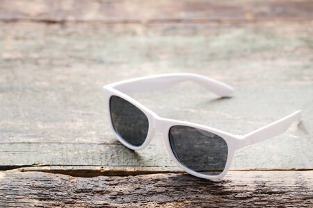 Fashion sunglasses on grey wooden tableの写真素材