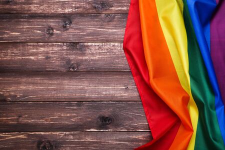 Rainbow flag on brown wooden tableの写真素材