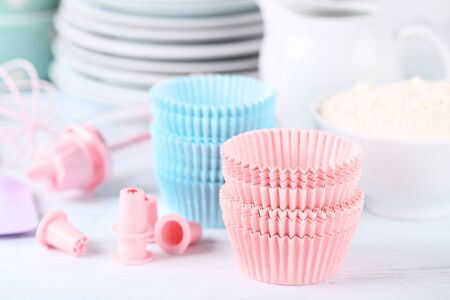 Colorful cupcake cases with kitchen utensils