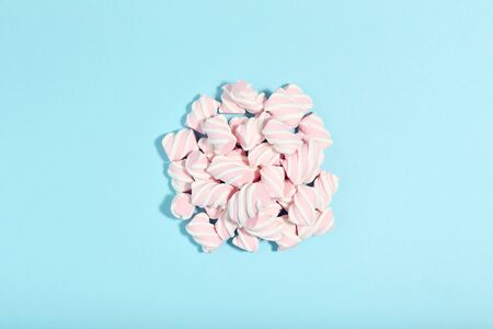 Sweet marshmallows on blue background. Minimalism conceptの写真素材