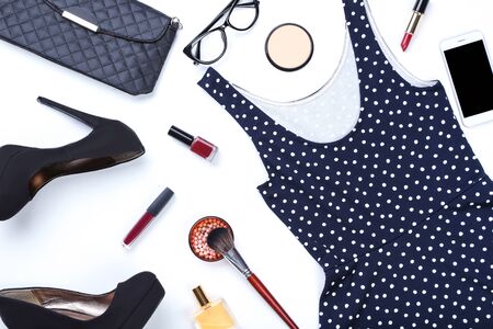Modern women's clothes with makeup cosmetics and accessories on white backgroundの写真素材