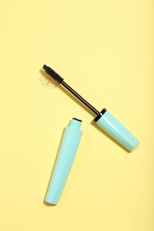 Makeup mascara on yellow background. Minimalism conceptの写真素材