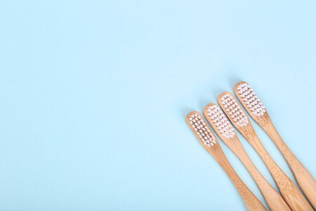 Bamboo toothbrushes on blue background