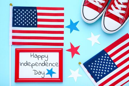 Text Happy Independence Day with american flag and sneakers on blue backgroundの写真素材
