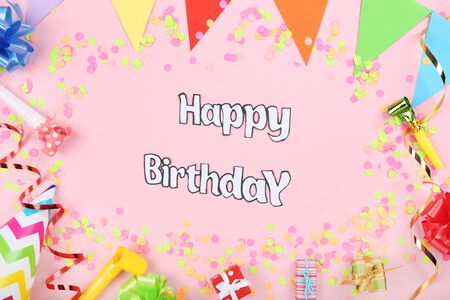 Text Happy Birthday with party decorations on pink backgroundの写真素材