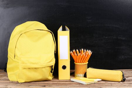 Backpack with school supplies on black backgroundの写真素材