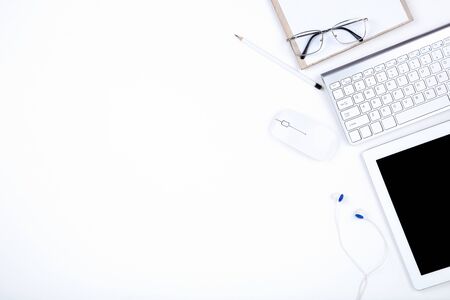 Tablet, keyboard computer with glasses, mouse and pencil on white backgroundの写真素材
