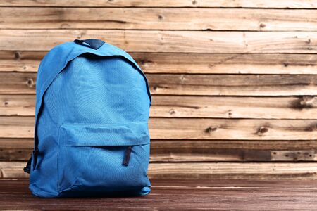 School backpack on brown wooden tableの写真素材