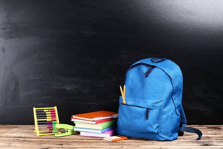 Backpack with school supplies on black backgroundの写真素材