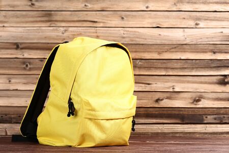 School backpack on brown wooden tableの写真素材