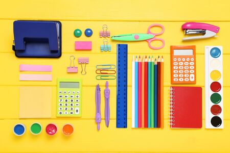 School supplies on yellow wooden tableの写真素材