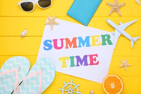 Fashion clothing with seashells and text Summer Time on yellow wooden tableの写真素材