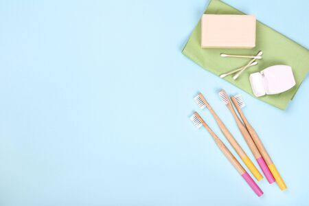 Bamboo toothbrushes with soap, cotton sticks and dental floss on blue backgroundの写真素材